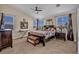 Bright bedroom featuring a ceiling fan, two large windows, and ample space for furnishings at 10662 Bonchester Hill St, Las Vegas, NV 89141