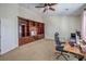 Home office space with custom built-in shelving and office desk at 10662 Bonchester Hill St, Las Vegas, NV 89141