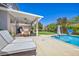 Spacious covered patio with comfortable seating and dining area overlooking the pool at 10662 Bonchester Hill St, Las Vegas, NV 89141