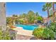 Serene backyard pool surrounded by lush landscaping, offering a private retreat at 10662 Bonchester Hill St, Las Vegas, NV 89141