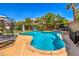 Beautiful backyard pool with blue water, decorative swans, and ample space for entertainment at 10662 Bonchester Hill St, Las Vegas, NV 89141