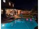 Inviting pool with outdoor seating area, lights, and a well-maintained lawn at 10662 Bonchester Hill St, Las Vegas, NV 89141