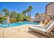 Stunning pool area with lounge chairs and privacy, creating a perfect spot for summer enjoyment at 10662 Bonchester Hill St, Las Vegas, NV 89141