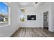 Bright bedroom featuring modern light fixture, light wood flooring and large windows with neighborhood views at 10748 Steel Ridge Ct, Las Vegas, NV 89135