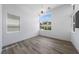 Bright bedroom with modern light fixture, light wood flooring and large windows at 10748 Steel Ridge Ct, Las Vegas, NV 89135