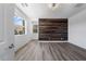 Bright bedroom featuring luxury vinyl plank flooring, shiplap accent wall, and natural light creates a cozy ambiance at 10748 Steel Ridge Ct, Las Vegas, NV 89135