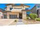 Contemporary home with a balcony, three-car garage, and landscaped front yard at 10748 Steel Ridge Ct, Las Vegas, NV 89135