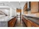 Kitchen featuring a large island with seating, stainless steel appliances, and custom cabinetry at 10748 Steel Ridge Ct, Las Vegas, NV 89135