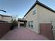 A view of the backyard, which features a covered patio and a brick-paved area, perfect for relaxing at 10941 Prudhoe Bay St, Las Vegas, NV 89179