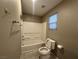 Bathroom featuring a bathtub-shower combo and toilet with gray tile floors at 10941 Prudhoe Bay St, Las Vegas, NV 89179