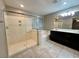 Bathroom featuring a glass enclosed shower, soaking tub, and a dual sink vanity with a large mirror at 10941 Prudhoe Bay St, Las Vegas, NV 89179