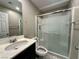 Bathroom featuring a glass enclosed shower, toilet, and a single sink vanity at 10941 Prudhoe Bay St, Las Vegas, NV 89179