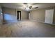 Large bedroom with carpeted floors and multiple access doors at 10941 Prudhoe Bay St, Las Vegas, NV 89179