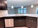 Kitchen with dark cabinetry, stainless steel appliances, granite countertops, pendant lighting, and tile floors at 10941 Prudhoe Bay St, Las Vegas, NV 89179