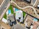 Aerial view of a modern home with a pool and green turf amidst a desert landscape at 11943 Rockview Point St, Las Vegas, NV 89138