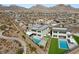 Aerial view of a modern home with a pool and desert landscape and community at 11943 Rockview Point St, Las Vegas, NV 89138