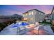 Backyard at dusk with a pool, fire pit, landscaping, and mountain views at 11943 Rockview Point St, Las Vegas, NV 89138