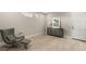 Cozy bedroom featuring a stylish chair, modern cabinet, and a large decorative mirror at 11943 Rockview Point St, Las Vegas, NV 89138