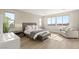 Serene bedroom with large windows, a cozy seating area, and modern décor at 11943 Rockview Point St, Las Vegas, NV 89138