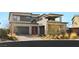 Contemporary two-story home with a three-car garage, mixed siding, desert landscaping, and paved driveway at 11943 Rockview Point St, Las Vegas, NV 89138