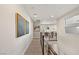 Bright hallway featuring wood floors, modern artwork, and a view of the staircase at 11943 Rockview Point St, Las Vegas, NV 89138