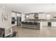 Modern kitchen with stainless steel appliances, center island with bar seating, and white cabinetry at 11943 Rockview Point St, Las Vegas, NV 89138