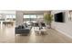 Spacious living room featuring a gray sofa, modern furniture and a sliding glass door to the pool area at 11943 Rockview Point St, Las Vegas, NV 89138