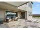 Covered patio with seating area, sliding glass doors, and outdoor flooring design at 11943 Rockview Point St, Las Vegas, NV 89138