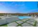 Backyard pool features a lounge area, turf accents, and a covered outdoor kitchen at 11943 Rockview Point St, Las Vegas, NV 89138