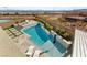 Aerial view of a private pool and landscaped backyard with lounge chairs and a dining area at 11943 Rockview Point St, Las Vegas, NV 89138