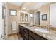 Bright bathroom featuring granite countertops, double sinks, and modern fixtures at 12 Wade Hampton Trl, Henderson, NV 89052