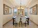 Elegant dining room featuring coffered ceilings, shuttered windows, and stylish furniture at 12 Wade Hampton Trl, Henderson, NV 89052