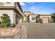 Attractive home exterior with a long driveway, well-maintained landscaping, and multiple garage spaces at 12 Wade Hampton Trl, Henderson, NV 89052