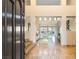 Grand foyer with high ceilings and a view into the spacious living room, showcasing elegant tile flooring at 12 Wade Hampton Trl, Henderson, NV 89052