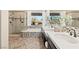 Bright main bathroom featuring double sinks, a soaking tub and seamless glass shower with stylish fixtures at 12 Wade Hampton Trl, Henderson, NV 89052