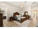 Beautiful main bedroom with wood floors, carved wood furniture and access to the main bathroom at 12 Wade Hampton Trl, Henderson, NV 89052