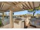 Luxurious outdoor kitchen with stone countertops, built-in grill, and ample seating, perfect for entertaining guests at 12 Wade Hampton Trl, Henderson, NV 89052