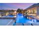 Beautiful swimming pool and spa featuring elegant tile work and lighting for a luxurious outdoor experience at 12 Wade Hampton Trl, Henderson, NV 89052