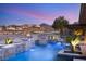 Backyard oasis with a pool, spa, fire bowls, and a lush desert landscape at 12 Wade Hampton Trl, Henderson, NV 89052