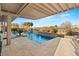 Stunning pool featuring cascading waterfalls, travertine decking, and lush landscaping for a resort-like experience at home at 12 Wade Hampton Trl, Henderson, NV 89052