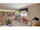 A cluttered bedroom with a window, shelving, and built-in cabinets at 1299 Brenalee Ave, Henderson, NV 89002