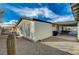 Home exterior featuring a gravel yard, covered patio and blue skies at 1299 Brenalee Ave, Henderson, NV 89002