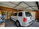 Well-lit garage space with storage and a white Pilot parked inside at 1299 Brenalee Ave, Henderson, NV 89002