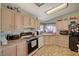 Eat-in kitchen features granite countertops and black appliances at 1299 Brenalee Ave, Henderson, NV 89002