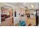 Bright kitchen featuring light wood cabinets, tile floors, and modern appliances, open to an adjacent living space at 1299 Brenalee Ave, Henderson, NV 89002