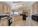 Eat-in kitchen features granite countertops and black appliances at 1299 Brenalee Ave, Henderson, NV 89002