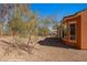 View of backyard with desert landscaping and covered patio at 1455 Waterfall Ln, Mesquite, NV 89034