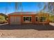 View of the backyard with desert landscaping and orange stucco exterior at 1455 Waterfall Ln, Mesquite, NV 89034