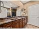 Bathroom features double sinks with granite countertop and dark wood cabinetry at 1455 Waterfall Ln, Mesquite, NV 89034