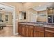 Bathroom features double sinks with granite countertop and dark wood cabinetry at 1455 Waterfall Ln, Mesquite, NV 89034